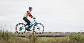 Marin Ambassador Juliet Elliott riding a Larkspur E on a bike path.