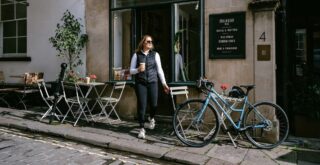 Woman walking out of a coffee shop to her Marin Nicasio ST bicycle.