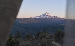 Mountain viewed through a tent door.