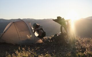 Marin ambassador Lynnee Jacks with her tent and Pine Mountain 2 at sunrise, Oregon.