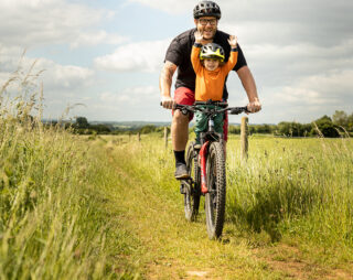 Father and son riding a mountain bike