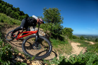 Rider going around berm in bike park riding marin san quentin