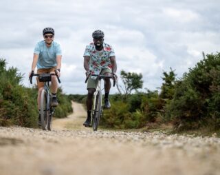 Two riders on Marin Nicasio bikes, rolling along on a gravel road, UK.